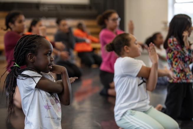 A group of young people stretching their arms