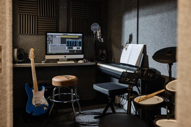 sound booth with mac guitar and practice keyboard set up
