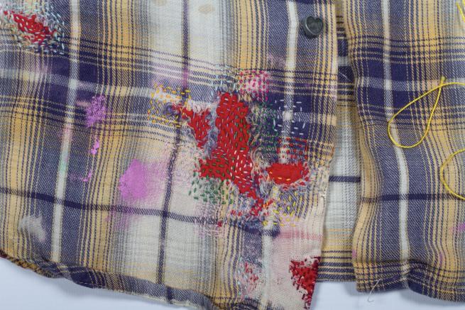 Shirt with colourful stitching repairs