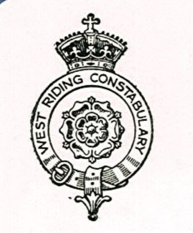 A copy of the West Riding Constabulary logo, a belt with buckle circles the Yorkshire rose, atop is a crown and below a fleur de lis
