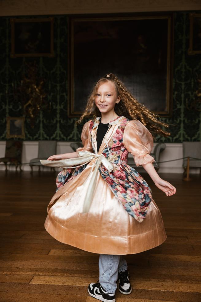 Girl twirling in fancy historic dress