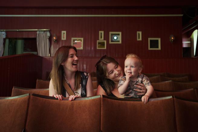 A family sat in a row of cinema seats