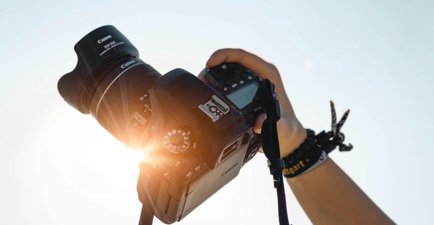 a hand holding a camera