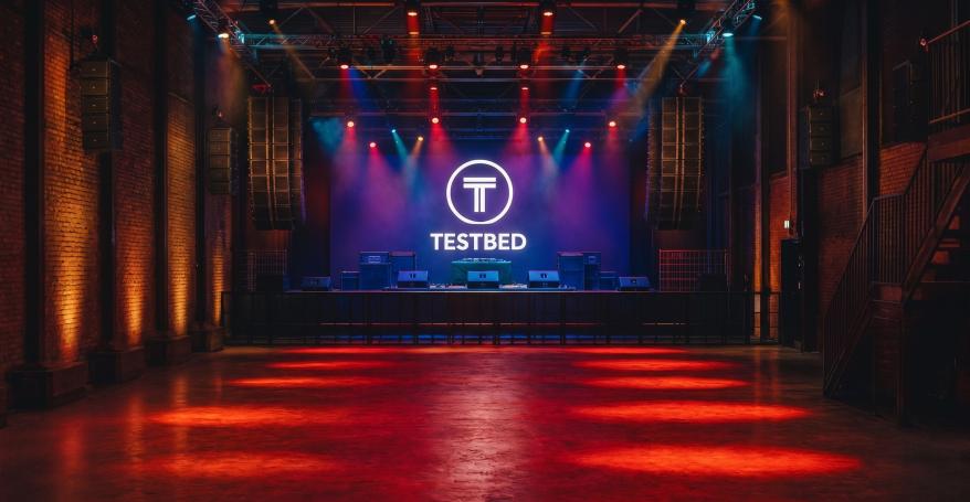 The purpose-built stage at Testbed and the brand-new mezzanine level with bar, seating and lockers for improved customer experience