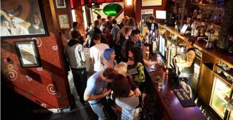 inside picture of bar showing people drinking