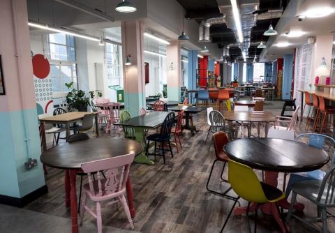 Photograph of tables and chairs in the Common Ground cafe.