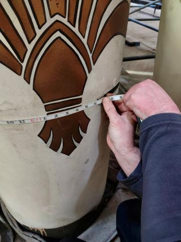 someone working on an organ pipe