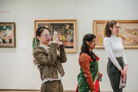 three people looking at an exhibition
