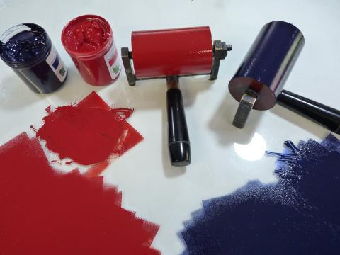 Print rollers and blue and red paint.