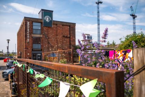 Northern Monk Refectory Leeds is a 3 storey, red brick building, with la large beer garden out the front.