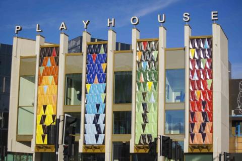 Th colourful front of the Leeds Playhouse building, with letters on top forming the word 'PLAYHOUSE'