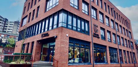 photograph of Mabgate Campus from the outside. It is a 4 storey red brick building with windows across all sides.