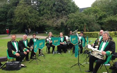 A brass band performing in a park. 