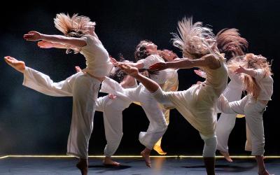 Dancers on stage jump in the air