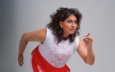 A woman poses as if she's about to start a race.